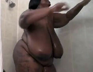 This Ample ebony damsel wanks in the shower. Her humungous