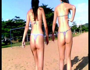 2 suntanned brown-haired young ladies in g-string bathing