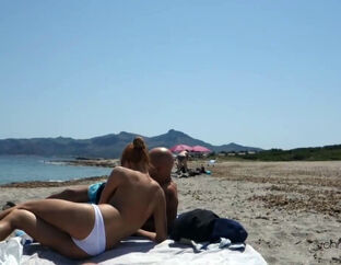 2 wives give oral pleasure at the beach for their hubbies